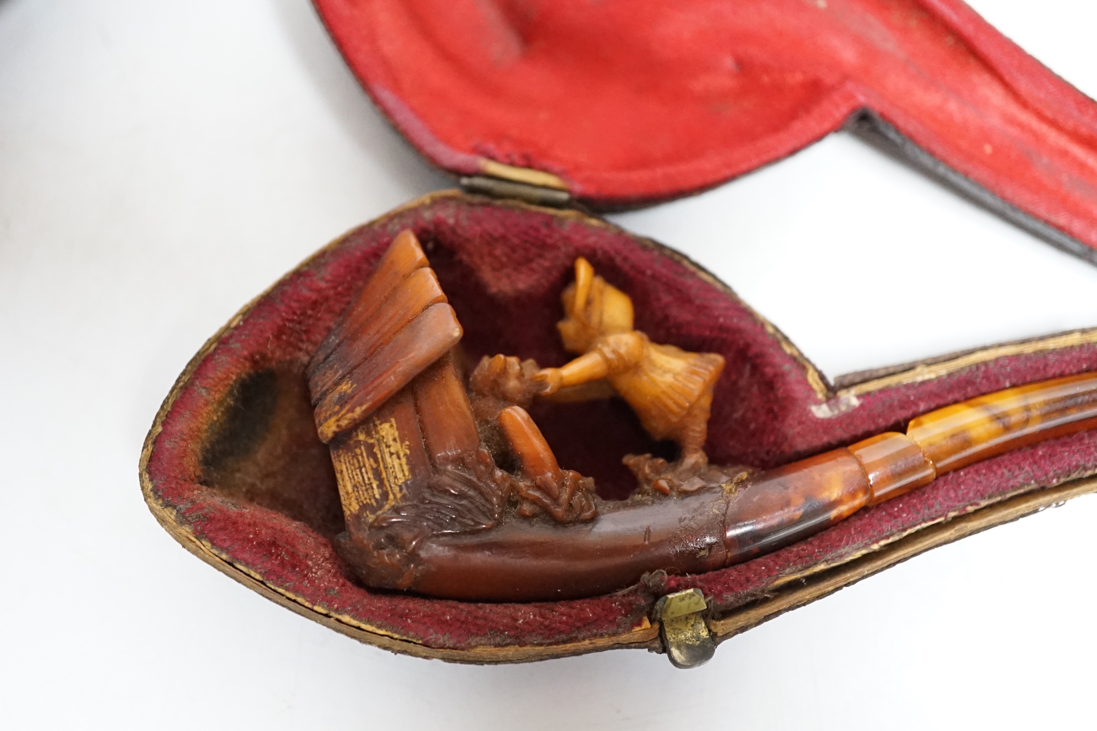 Three cased pipes, one with carved amber novelty bowl, the other two with amber pipe ends, metal mounted, together with a tortoiseshell and mother of pearl card case, Card case 10.5cm high x 8cm wide